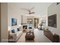 Bright, staged living room with fireplace, ceiling fan, and dining area at 7155 S Durango Dr # 309, Las Vegas, NV 89113