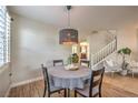 Cozy dining area featuring a modern light fixture and easy access to the living room at 75 Archer Glen Ave, Henderson, NV 89002
