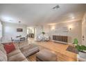 Spacious living room featuring hardwood flooring, modern decor, and ample natural light at 75 Archer Glen Ave, Henderson, NV 89002