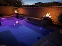 Tranquil pool at twilight with fire features, creating a warm and inviting outdoor ambiance at 7630 Canyon Diablo Rd, Las Vegas, NV 89179