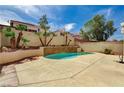 Backyard view highlighting the pool, patio, and privacy wall at 7637 Good Fortune Ct, Las Vegas, NV 89139