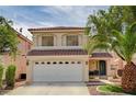Charming two-story home showcasing a well-maintained lawn and attached two-car garage at 7637 Good Fortune Ct, Las Vegas, NV 89139