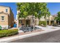 Street view of house featuring a covered porch, lush tree, and private drive at 7645 Interlace St, Las Vegas, NV 89149