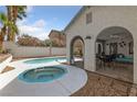 Backyard featuring a pool, spa, covered patio, and lush landscaping at 823 Schooner Dr, Henderson, NV 89015