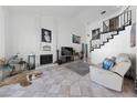 Spacious living area featuring a brick fireplace, open staircase, and stylish decor at 823 Schooner Dr, Henderson, NV 89015