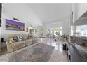 Bright living room with tile floors, large windows, and stylish decor at 823 Schooner Dr, Henderson, NV 89015