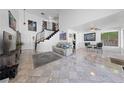 Bright living room with staircase, neutral decor, and an adjacent dining area at 823 Schooner Dr, Henderson, NV 89015
