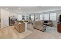 Spacious living room featuring neutral tones, lots of natural light, modern furniture and an open floor plan at 8786 Sand Verbena Ave, Las Vegas, NV 89117