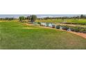 Expansive golf course with lush green fairways, water features, and mature trees at 9024 Starmount Dr, Las Vegas, NV 89134