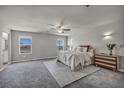 Spacious bedroom with carpet flooring, natural lighting, ceiling fan, and neutral tones at 9876 Magnus Ct, Las Vegas, NV 89178