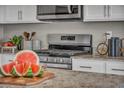 Well-equipped kitchen with stainless steel appliances, granite countertops, and modern finishes at 9876 Magnus Ct, Las Vegas, NV 89178