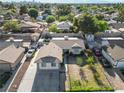 This aerial view showcases the property's layout within a quiet residential neighborhood with lush greenery and city views at 1105 Declaration Dr, Las Vegas, NV 89110