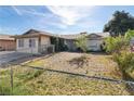 Quaint single-level home with a chain-link fenced yard, providing a secure space at 1105 Declaration Dr, Las Vegas, NV 89110