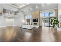 Bright living room featuring high ceilings, stone fireplace, and sliding doors to the outdoor space at 13 Dovetail Cir, Henderson, NV 89014