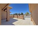 Covered porch area with stucco pillars and low walls, desert landscaping and a gravel yard at 1361 Moose St, Pahrump, NV 89048