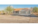 Charming single-story home with a terracotta tile roof and a spacious three-car garage at 1601 Iguana St, Pahrump, NV 89048