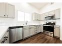 Modern kitchen with stainless steel appliances, ample counter space, and stylish dark wood flooring at 1601 Iguana St, Pahrump, NV 89048