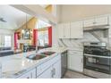 Kitchen area with marble countertops, stainless steel appliances, and an open floor plan at 169 Alterra Dr, Henderson, NV 89074