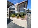 Two-story condo exterior featuring well-maintained landscaping, covered parking, and a welcoming facade at 1748 Jupiter Ct # C, Las Vegas, NV 89119