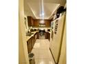 Functional kitchen featuring wooden cabinets, laminate countertops, and stainless steel appliances at 1748 Jupiter Ct # C, Las Vegas, NV 89119