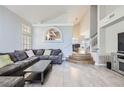 Bright and airy living room with vaulted ceilings, tile floors, and a comfortable sectional sofa at 2418 Antler Point Dr, Henderson, NV 89074