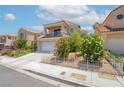 Inviting two-story home with a balcony, two-car garage, and verdant landscaping, nestled in a desirable neighborhood at 2452 Silver Shadow Dr, Las Vegas, NV 89108
