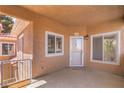 Private balcony entry featuring a secure door, bright windows, and exterior lighting at 251 S Green Valley Pkwy # 1421, Henderson, NV 89012