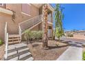 Exterior stairway leading to the condos, surrounded by well-maintained landscaping and mature trees at 251 S Green Valley Pkwy # 1421, Henderson, NV 89012