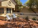 Outdoor brick patio featuring two white Adirondack chairs and an ornate white fence at 2553 Showcase Dr, Las Vegas, NV 89134