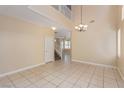 Bright living area features an open floorplan, high ceiling, staircase, and tile flooring at 3037 Austin Pale Ave, North Las Vegas, NV 89081