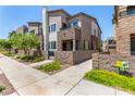 Charming townhome showcasing manicured landscaping, a gated patio, and modern architectural details at 328 Owens Peak Dr, Henderson, NV 89015