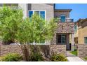 Stunning townhome with stone accents, a cozy balcony, and a well-maintained front garden at 328 Owens Peak Dr, Henderson, NV 89015