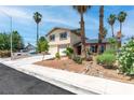 Two story home with desert landscaping, a two-car garage and mature palm trees at 3793 Casa Colorado Ave, Las Vegas, NV 89121