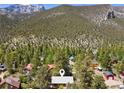 Scenic aerial view of the property nestled in a lush, mountainous neighborhood at 3971 Arlberg Way, Mount Charleston, NV 89124