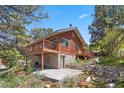 A picturesque home featuring a deck, cement patio, and beautifully landscaped yard at 3971 Arlberg Way, Mount Charleston, NV 89124