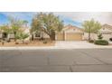 Charming single-story home showcasing a well-maintained yard, mature trees, and a spacious three-car garage at 4065 Genoa Dr, Las Vegas, NV 89141