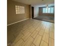 Open-concept living space with tile floors in front and carpet in the back, lots of natural light, and ceiling fan at 4108 Fairywren Dr, North Las Vegas, NV 89031