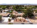 This spacious single-story home boasts a swimming pool, desert landscaping, and views of Las Vegas at 4219 E Pinecrest Cir, Las Vegas, NV 89121