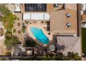 This home features a backyard with a unique kidney-shaped pool surrounded by lush landscaping at 4219 E Pinecrest Cir, Las Vegas, NV 89121