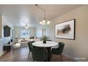 Cozy dining area boasts a modern chandelier and stylish table set at 4725 Basilicata Ln # 204, North Las Vegas, NV 89084