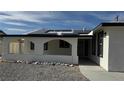 This home boasts a covered porch with stone and stucco details and solar panels on the roof at 5239 Treasure Ave, Las Vegas, NV 89122