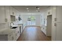 Bright kitchen featuring white cabinets, gold hardware, and stainless steel appliances at 5239 Treasure Ave, Las Vegas, NV 89122