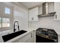 Bright kitchen with white cabinets, stainless steel appliances, and a modern faucet at 56 Belle Ridge Ave, Las Vegas, NV 89123