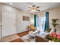 Cozy living room features wood floors, a gray sofa, and a sliding glass door for natural light at 5751 E Hacienda Ave # 154, Las Vegas, NV 89122
