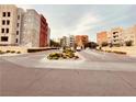 Inviting entrance to the Manhattan Condominiums, with mature landscaping at 62 E Serene Ave # 115, Las Vegas, NV 89123