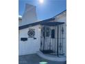 Close up of charming front porch with ironwork and unique architectural details on a bright, sunny day at 621 S 9Th St, Las Vegas, NV 89101