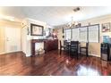 Open dining room with dark hardwood floors, modern lighting, and a full dining set at 6529 Hartwood Rd, Las Vegas, NV 89108