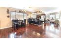 Open dining room featuring hardwood floors, modern lighting, and stylish black dining set at 6529 Hartwood Rd, Las Vegas, NV 89108