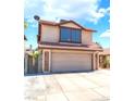 Two story home with tile roof, an attached garage, and a manicured front lawn under a blue sky at 6529 Hartwood Rd, Las Vegas, NV 89108
