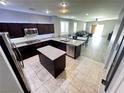 Spacious open kitchen with granite countertops, stainless steel appliances, and a center island at 7035 Thistle Ridge St, Las Vegas, NV 89166